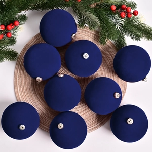 9-piece set of dark blue velvet flocked Christmas balls on a rustic woven mat