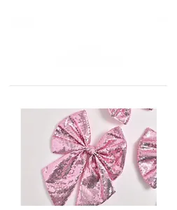 Detailed view of pink sequined Christmas tree bow ornament for festive party decorations