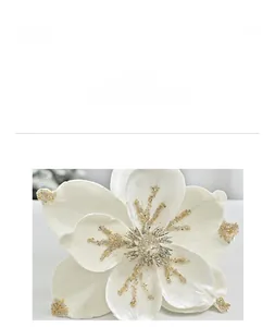 Macro shot of white flocked Christmas flower petal with gold and silver glitter details