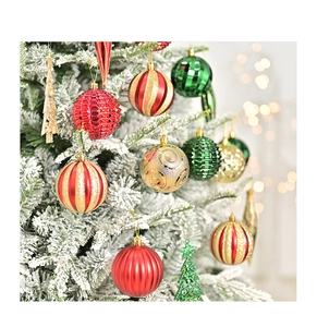Close-up of decorative Christmas balls and star hanging on a snow-flocked tree