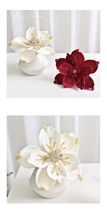 Detail of velvet magnolia petals with glitter edges and elegant ceramic vase