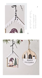 Detailed view of hollow wooden house ornaments and Merry Christmas engraved plaques