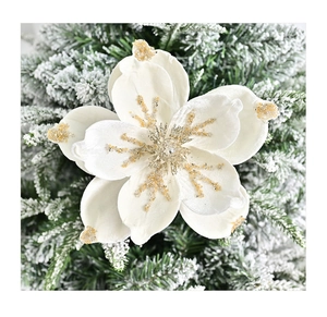 Macro shot of white velvet magnolia with gold glitter edges on Christmas tree branch