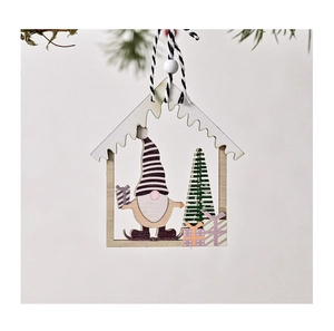 Detailed view of hollow house-shaped wooden Christmas ornament with painted gnome and tree
