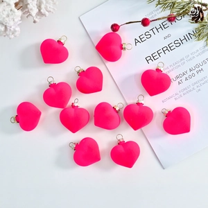 Set of 12 vibrant hot pink flocked heart ornaments with gold hooks for festive decoration