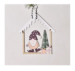 Close-up of wooden house-shaped Christmas tree ornament with gnome and tree detail