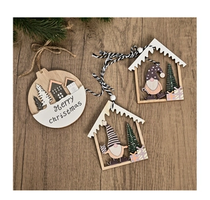 Detailed view of laser-cut wooden Christmas ornaments with house and gnome motifs