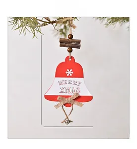 Macro shot of red wooden Merry Xmas bell ornament with hollow design and festive jute bow