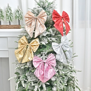 Five assorted glitter Christmas tree bow ornaments in red gold silver and pink
