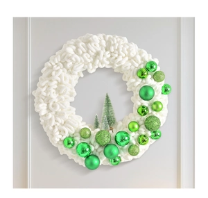 Close-up of white chenille plush wreath with green baubles and miniature Christmas trees