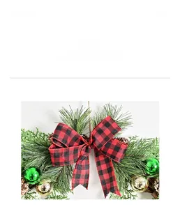 Close-up of Christmas wreath with buffalo plaid bow, pine needles and gold ornaments