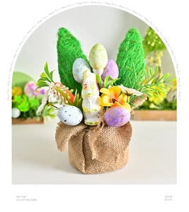 Close-up of Easter desktop ornament with burlap base, straw rabbit ears, and colorful eggs