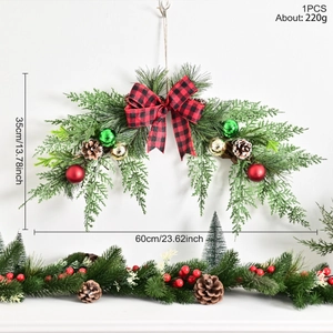 Christmas wreath with pine needles, bows and balls hanging on a white wall, 60x35cm