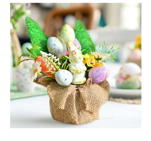 Close-up of Easter desktop decoration with bunny, colorful eggs, and linen base
