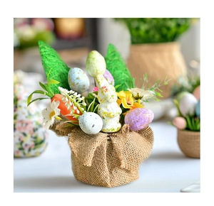 Detail of Easter bunny, spotted eggs, and carrot in a rustic burlap bag base