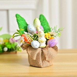 Easter tabletop decoration featuring bunny ears, colorful eggs, and carrots in burlap base