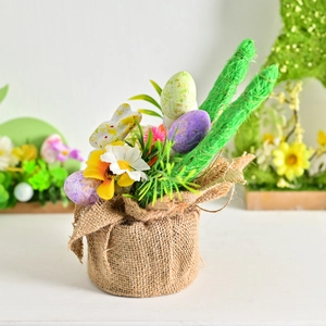 Easter simulated potted plant with burlap base, spring flowers and colorful speckled eggs