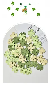 Detail of multi-toned green wood clover ornaments stacked on a magazine for St. Patrick's Day