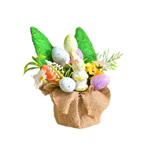 Easter table centerpiece with bunny, speckled eggs and carrots on burlap base