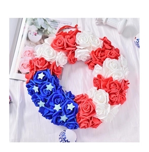Detail view of July 4th patriotic wreath with red white blue foam roses on satin fabric