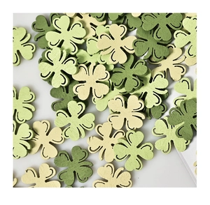 Flat lay of green wooden shamrock cutouts for St. Patrick's Day party decor and DIY crafts