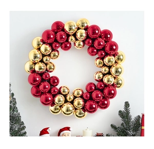 Close-up of a festive Christmas wreath featuring shiny red and gold electroplated ornaments