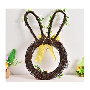 Detail of bunny-shaped rattan Easter wreath with spotted eggs and a yellow plaid bow