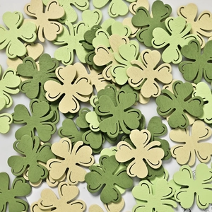 Green and white wooden shamrock cutouts for St. Patrick's Day party decorations