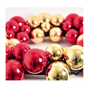 Close-up of shiny red and gold Christmas baubles with reflective mirror finish