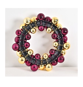 Detail showing the back structure of Christmas wreath with purple and gold baubles