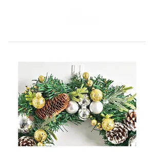 Detail of Nordic Christmas wreath with pine needles, cones and gold silver baubles