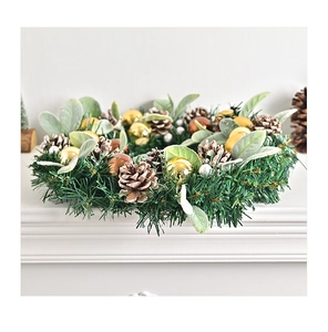 Close-up of Nordic Christmas wreath with pine cones, golden balls, and white berries