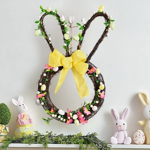 Easter bunny rattan wreath with spring flowers, colorful eggs and yellow plaid bow tie