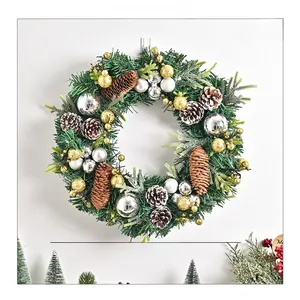 Detail of a 35cm Christmas wreath with green pine needles, pine cones and festive ornaments