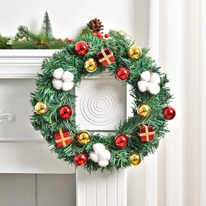 Vintage Weihnachtskranz mit Tannennadeln, rot-goldenen Kugeln und Baumwolle auf Kamin