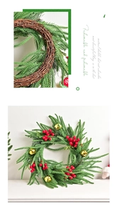 Detail of Norfolk fir wreath with red berries and golden bells on a brown vine base