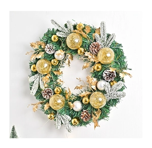 Detail of Christmas wreath with pine needles, cones, and gold and silver ornaments