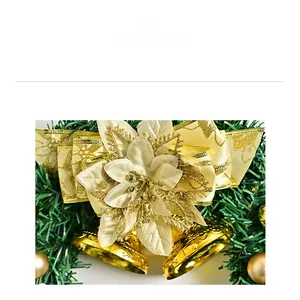 Detail of Christmas wreath with golden glitter flower, cream bow, and shiny bells