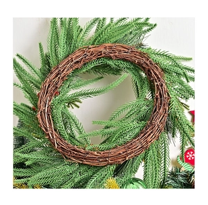 Close-up of a rustic Norfolk fir Christmas wreath with natural woven vine base