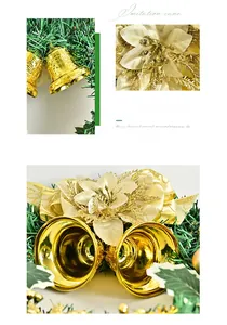 Close-up of golden bells and silk flower on green pine needle Christmas wreath