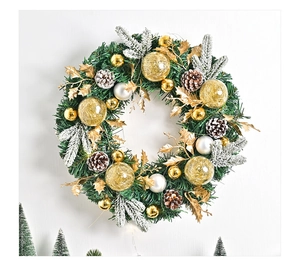 Detail of Nordic Christmas wreath with gold pine cones, silver baubles and snowy pine needles