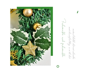 Detail of Christmas wreath featuring golden balls, stars, elk and frosted pine needles