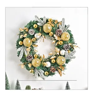 Detail of Christmas wreath featuring pine needles, cones and gold ornaments, 35cm diameter