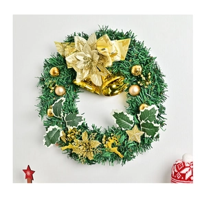 Close-up of Christmas wreath with golden bells, reindeer and shimmering pine needles