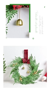 Detail of Christmas wreath with red plaid bow, golden bells and berries on cedar branches
