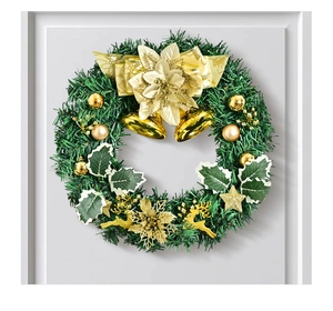 Detailed view of Christmas wreath with gold bells, reindeer ornaments and pine needles