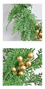 Close-up of golden berries and green pine needles on Christmas wreath ornament