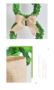 Detail of Easter bunny topiary wreath with boxwood leaves and a rustic burlap bow decoration