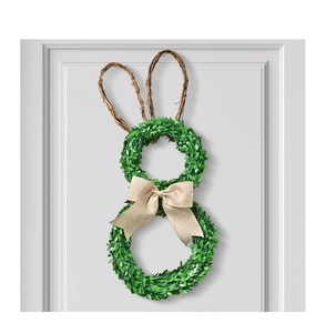 Detail of bunny-shaped greenery wreath with rustic twig ears and a beige burlap bow