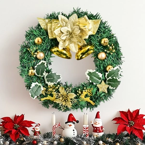 Lush Christmas wreath with gold bells, bow, and reindeer decor hanging on a white wall